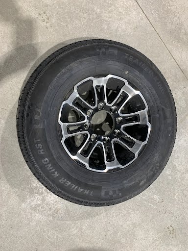 Discovery White Hawk aluminum rims on truck wheels, showcasing durable, lightweight aluminum design for cargo trailer customization.