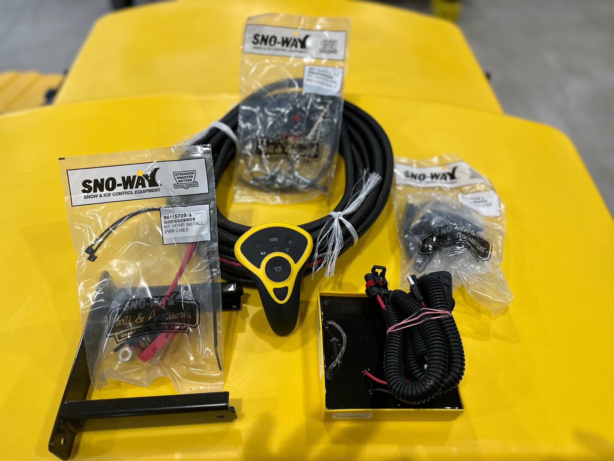 Wireless transmitter kit for Sno-Way variable speed control system, featuring electronic components and remote control device.