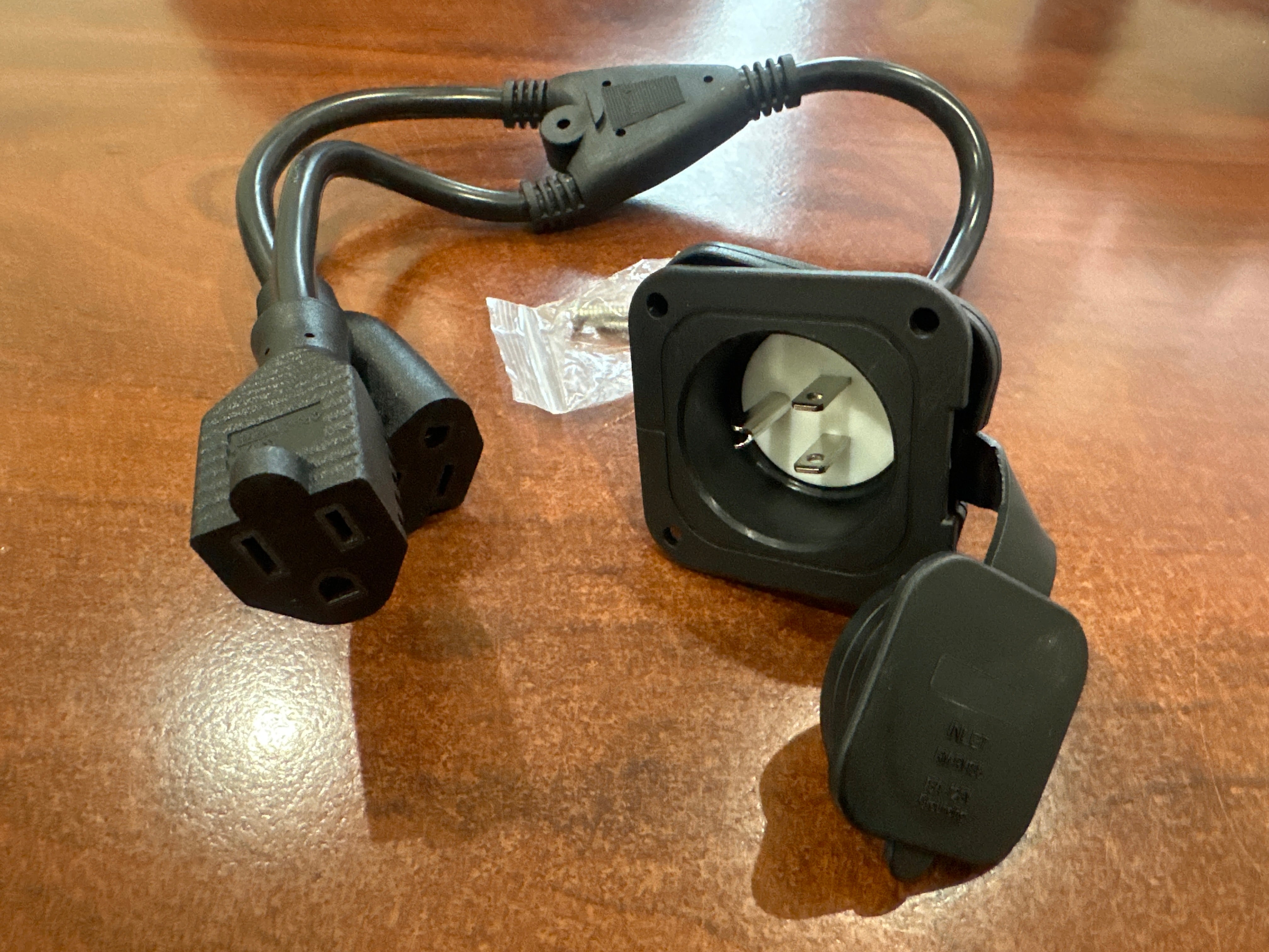 15 amp power inlet port plug for 125V electrical systems, designed for trailers and RVs by Indiana Trailer Sales.