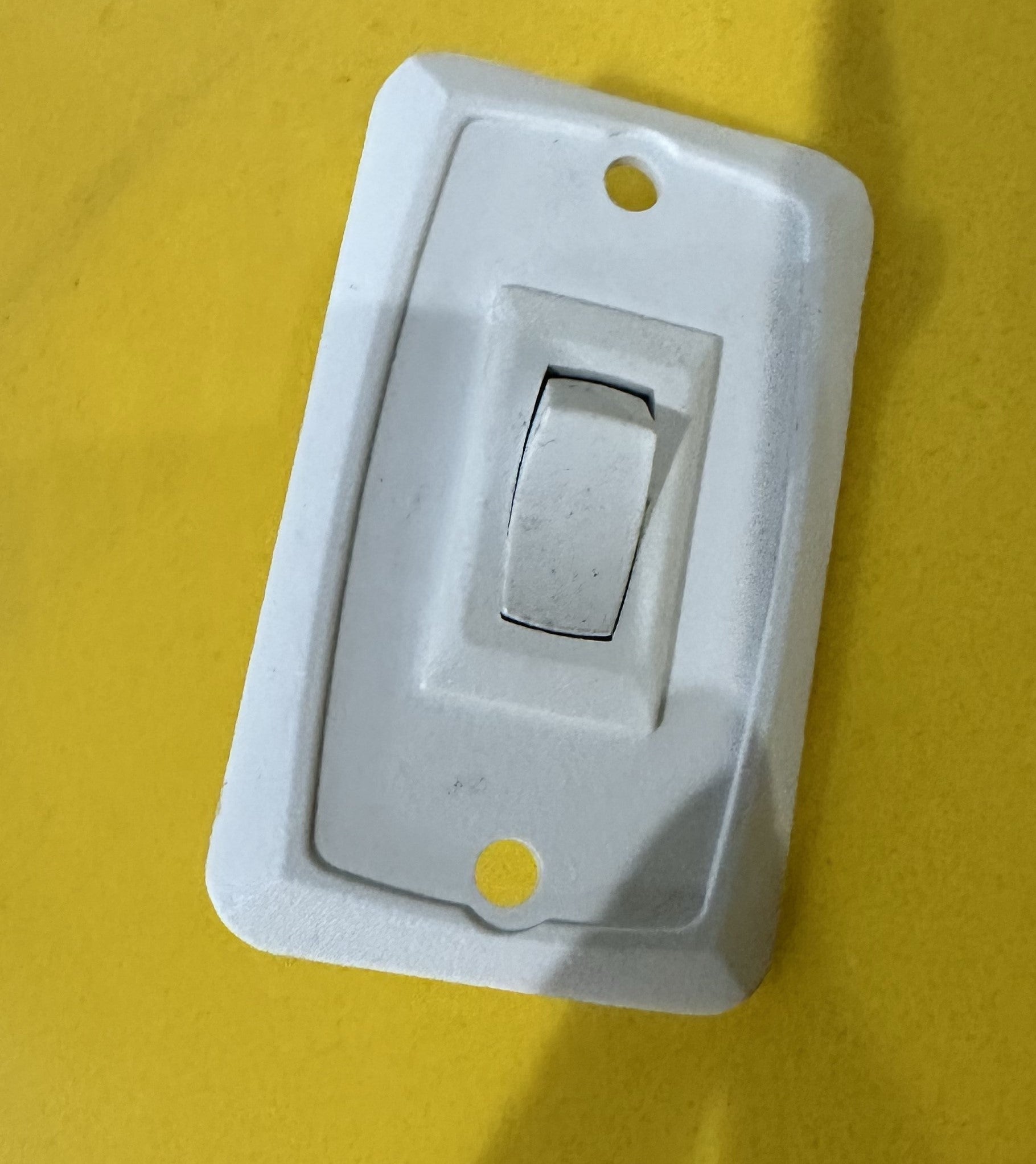 Three-way light switch from Indiana Trailer Sales for electrical lighting control, with visible switch and wiring.