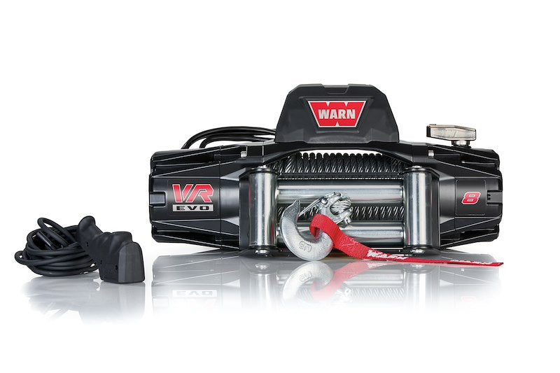Warn winch with 8,000-pound capacity and 94-foot wire rope, mounted on a vehicle for heavy-duty pulling tasks.