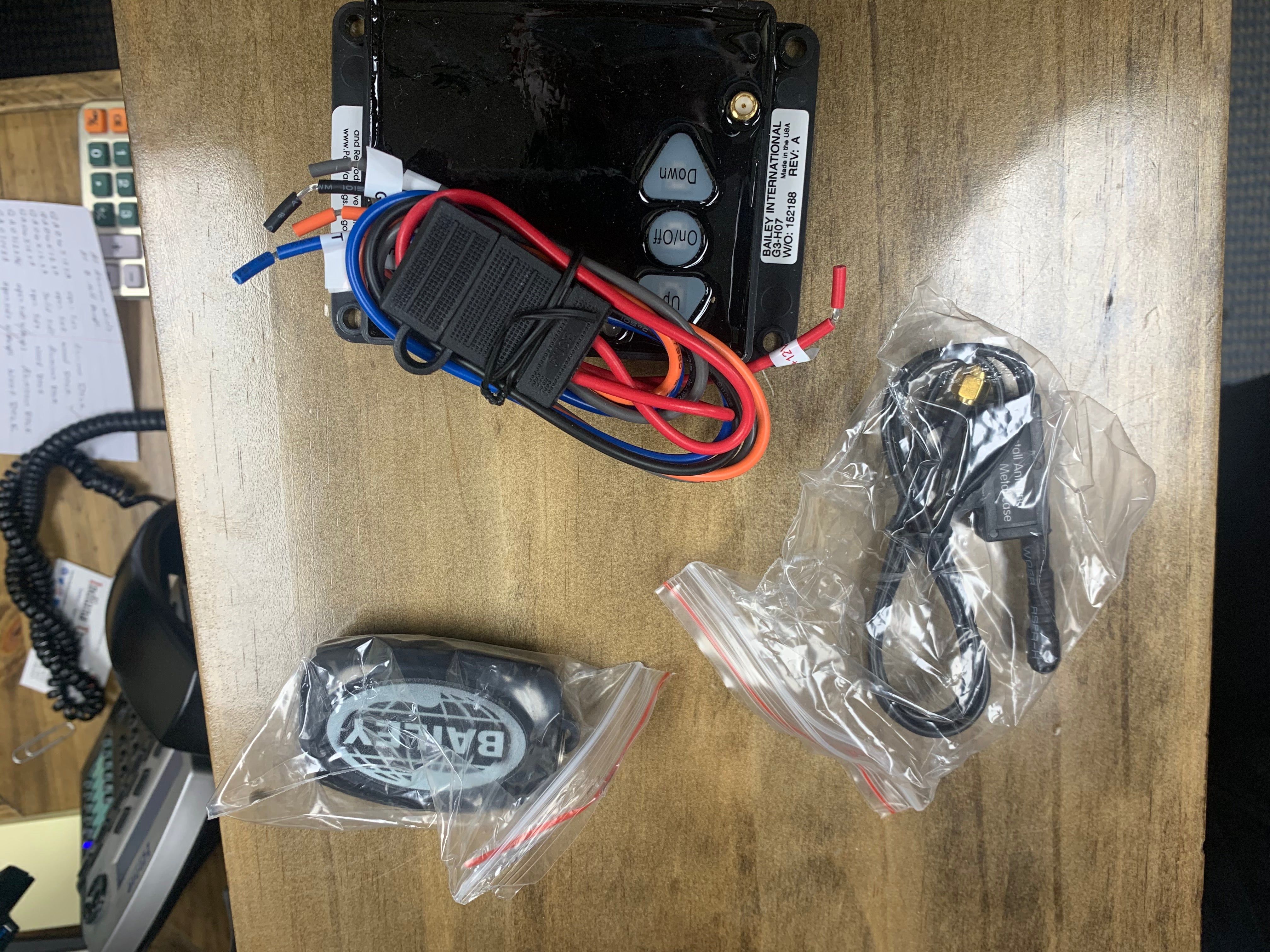 Universal wireless remote for hydraulics from BWISE + BRI-MAR Trailers, handheld control device for hydraulic systems.