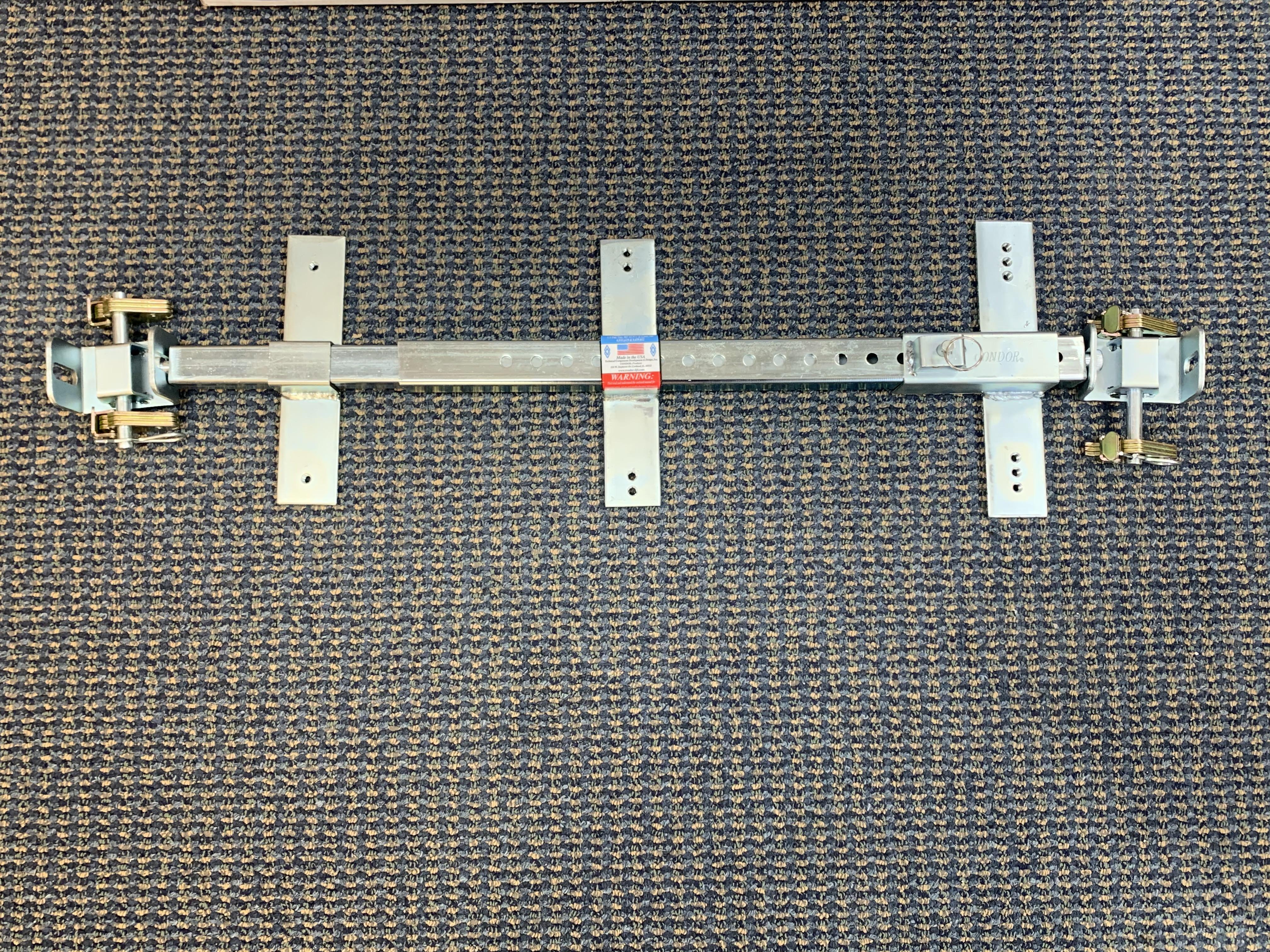 Condor Universal E-Track Adapter for towing accessories, shown in black with metal hooks and fittings for secure cargo attachment.