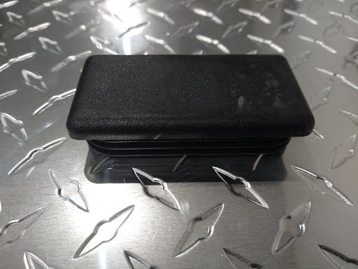 Plastic cap for body and frame components, measuring 2x4 inches, made by PJ Trailers MFG Inc.