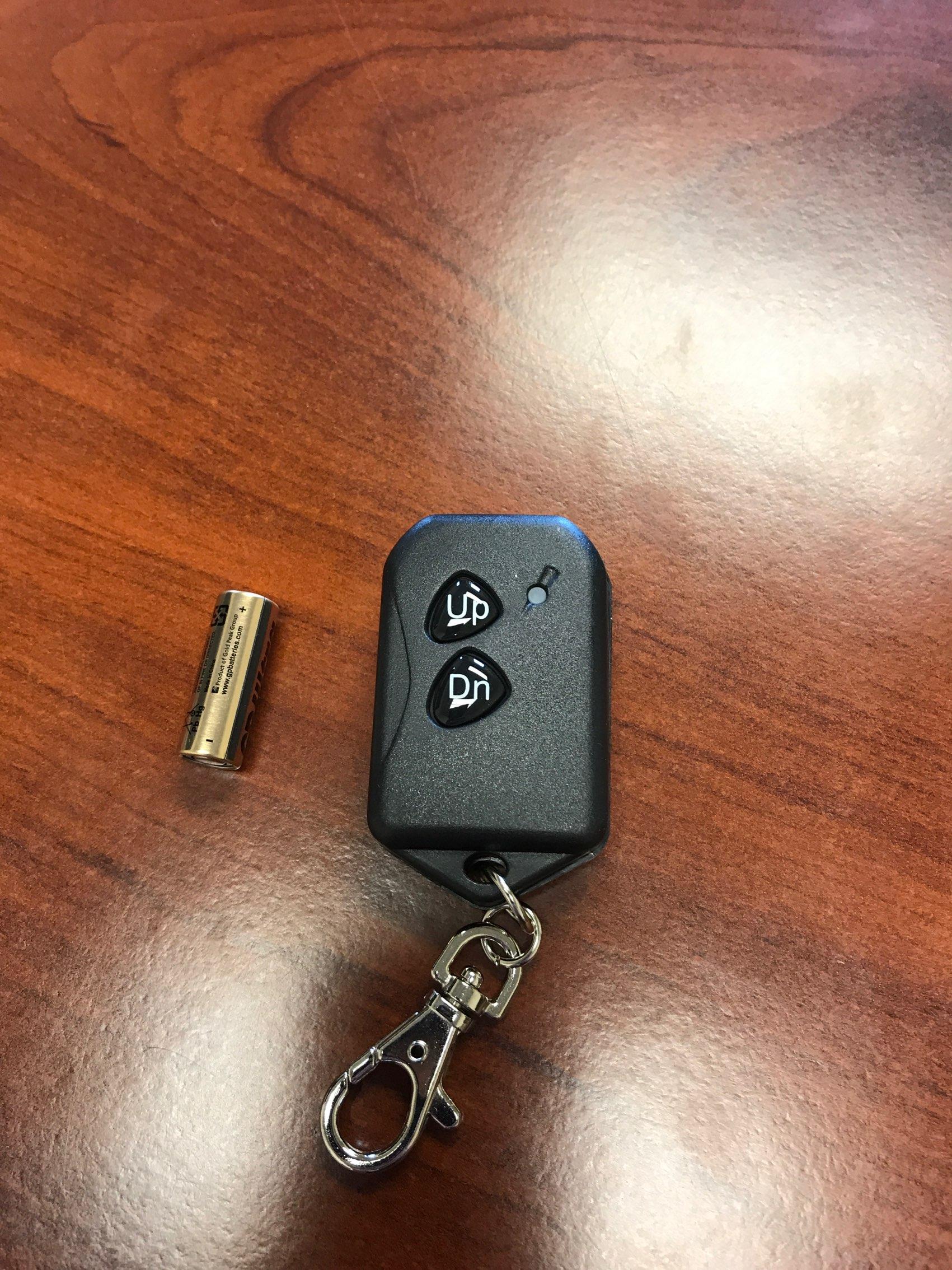 PJ Trailers MFG hydraulic transmitter keychain with wireless remote for easy hydraulic control.