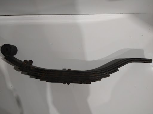 Spring Slip 6 leaf suspension from PJ Trailers MFG, Inc., showing a close-up of the durable leaf spring assembly.