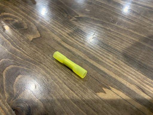 Yellow heat connector butt splice for 12-10 gauge wires from Tex Trail, used in electrical and lighting applications.