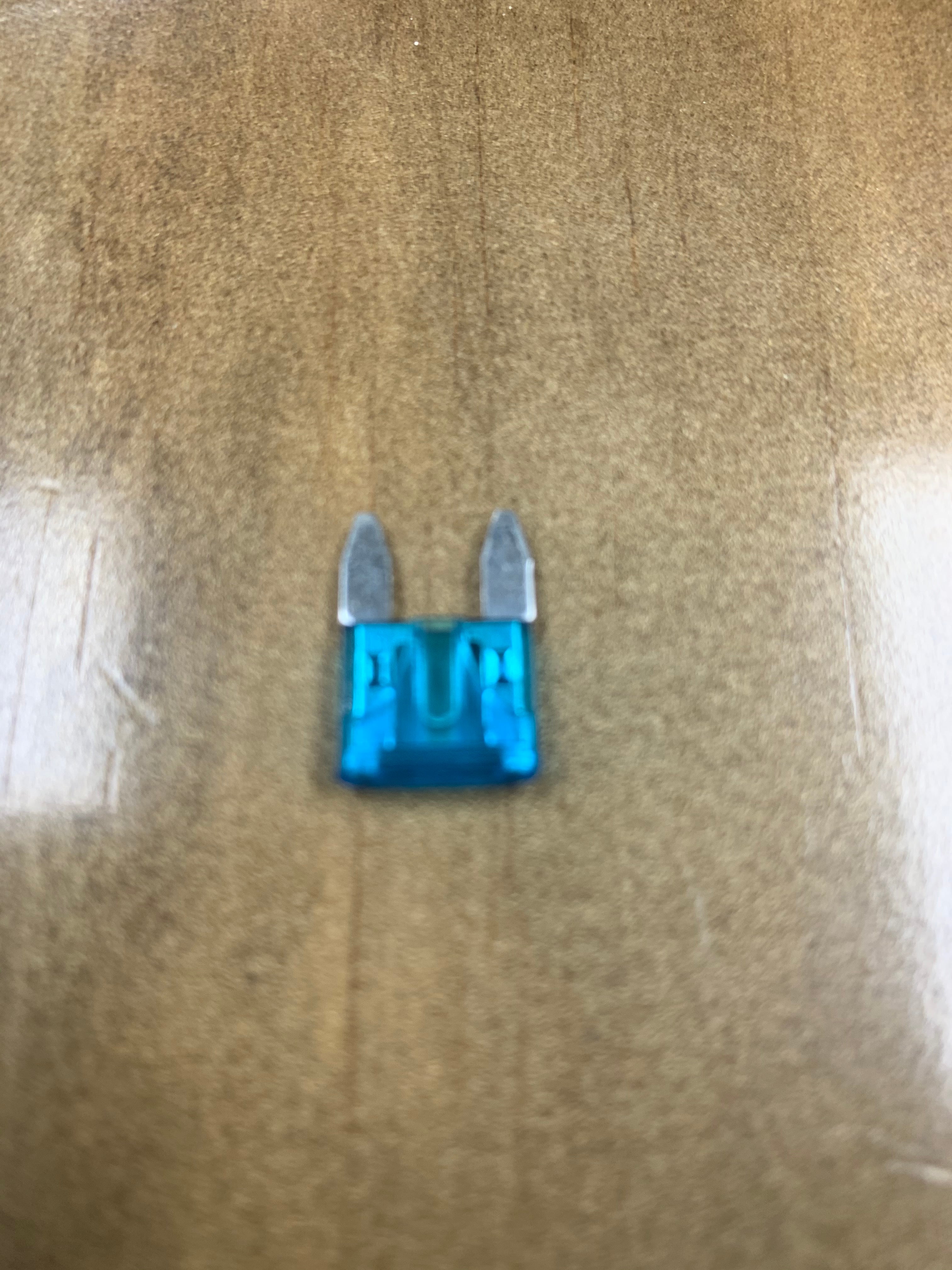 Blue FUSE 15 AMP blade mini fuse from Tex Trail for electrical and lighting applications, shown in a close-up image.