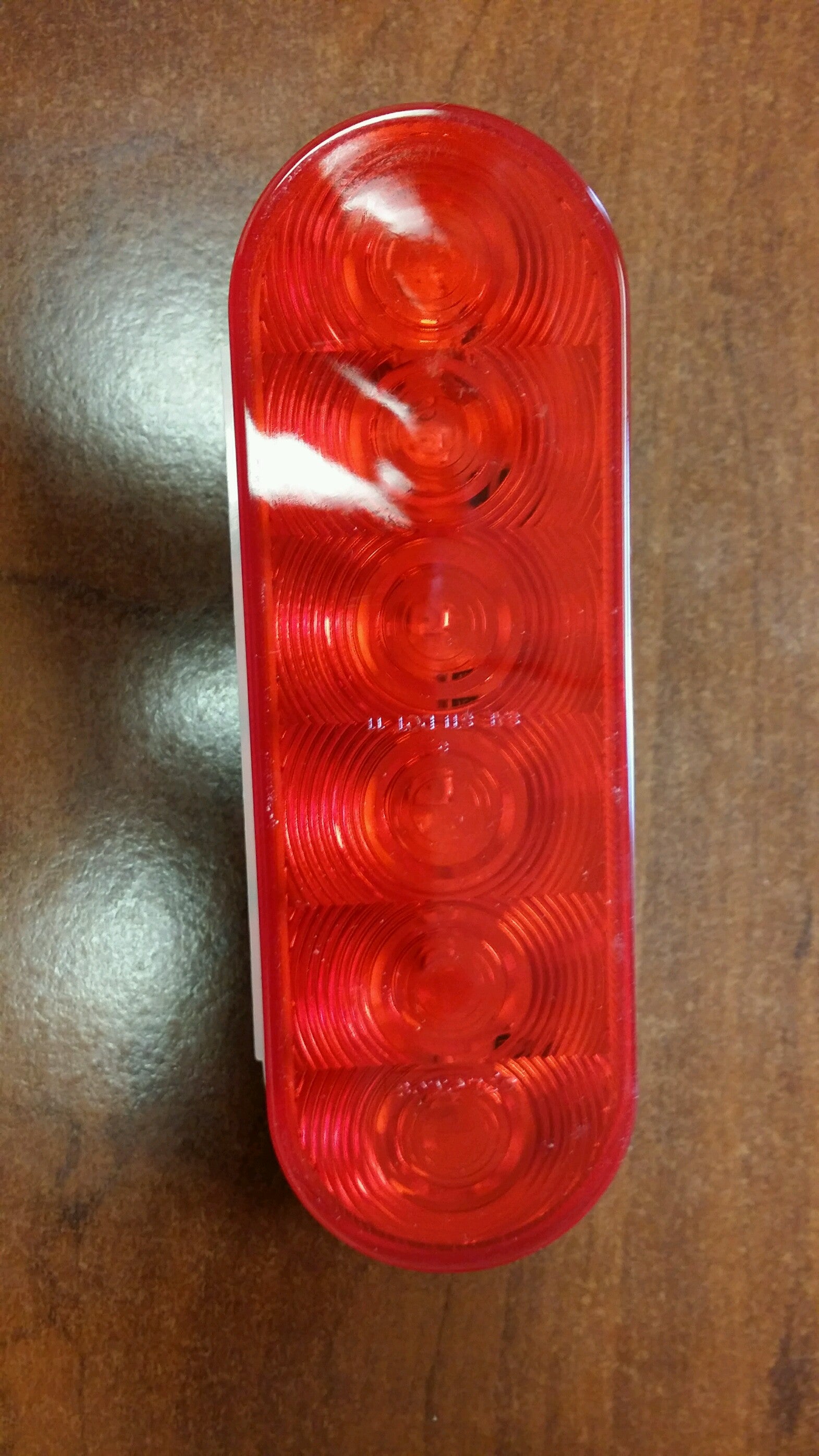 Red LED STT 6 Oval 6D light from Tex Trail, electrical and lighting product with a sleek oval design.