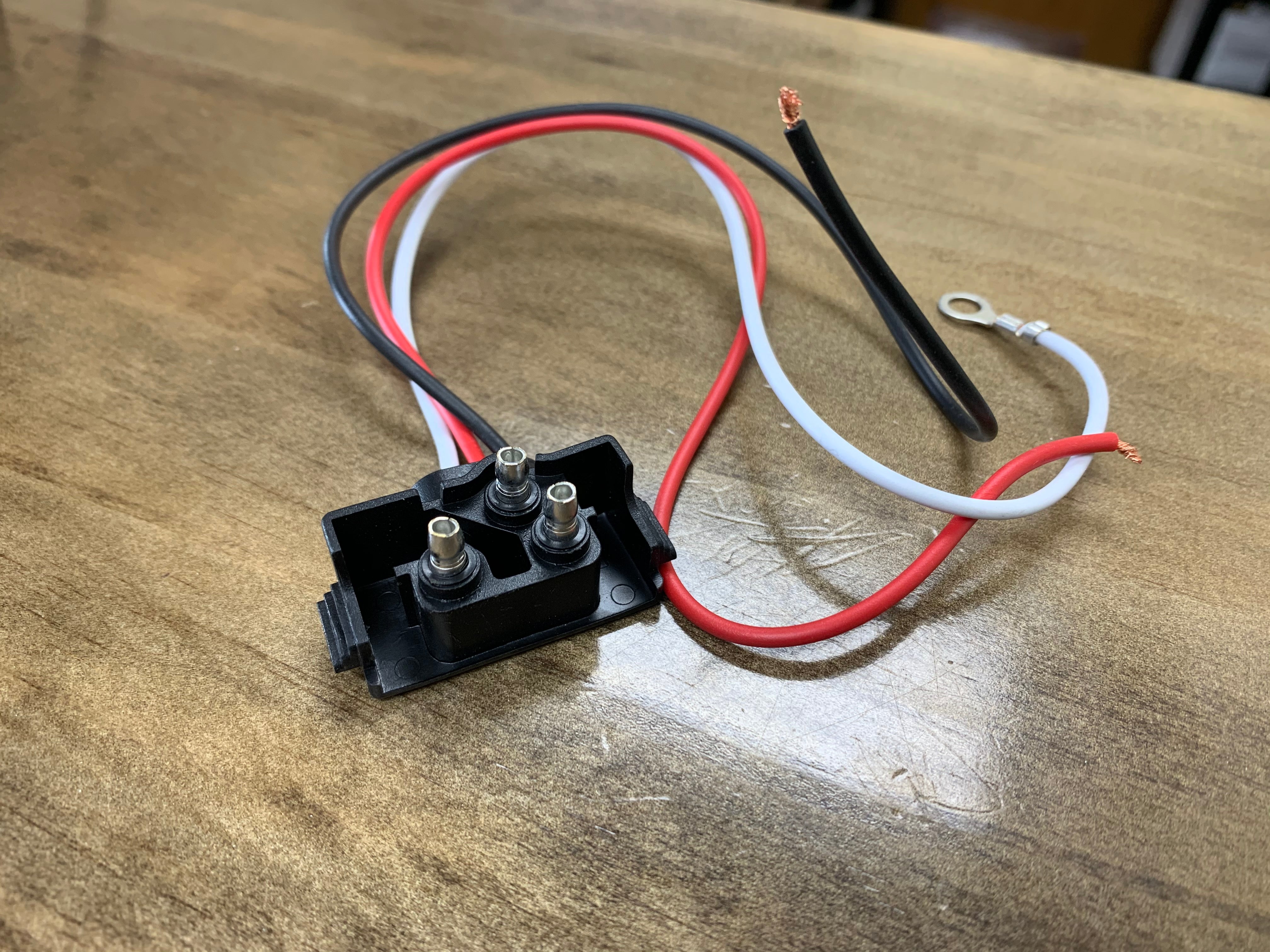 Tex Trail PL3 Pigtail Right Angle electrical connector for lights, featuring a compact right-angle design for easy wiring.