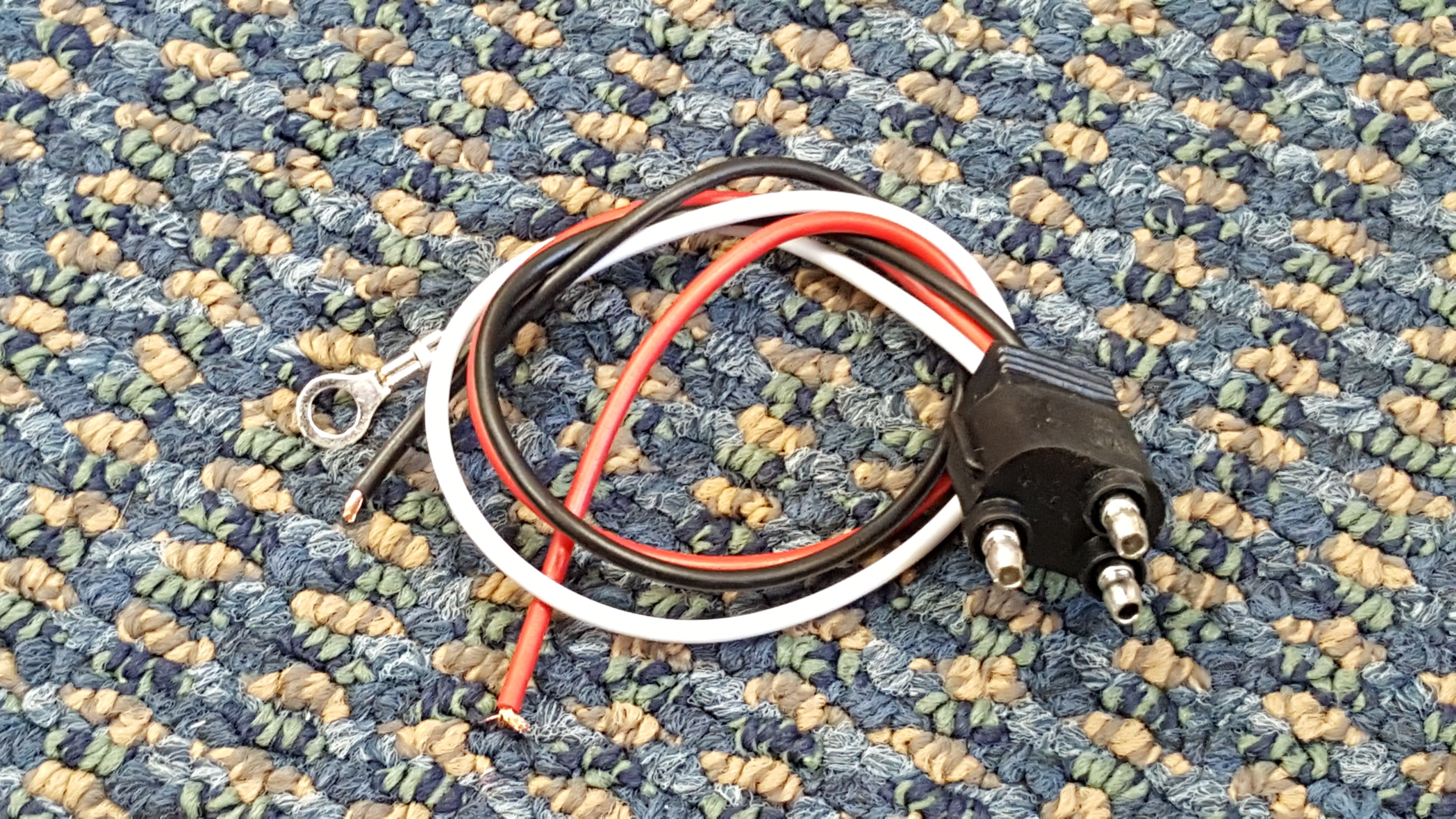 Tex Trail PL3 Pigtail Straight electrical connector for lights and electrical systems, shown in a close-up image.
