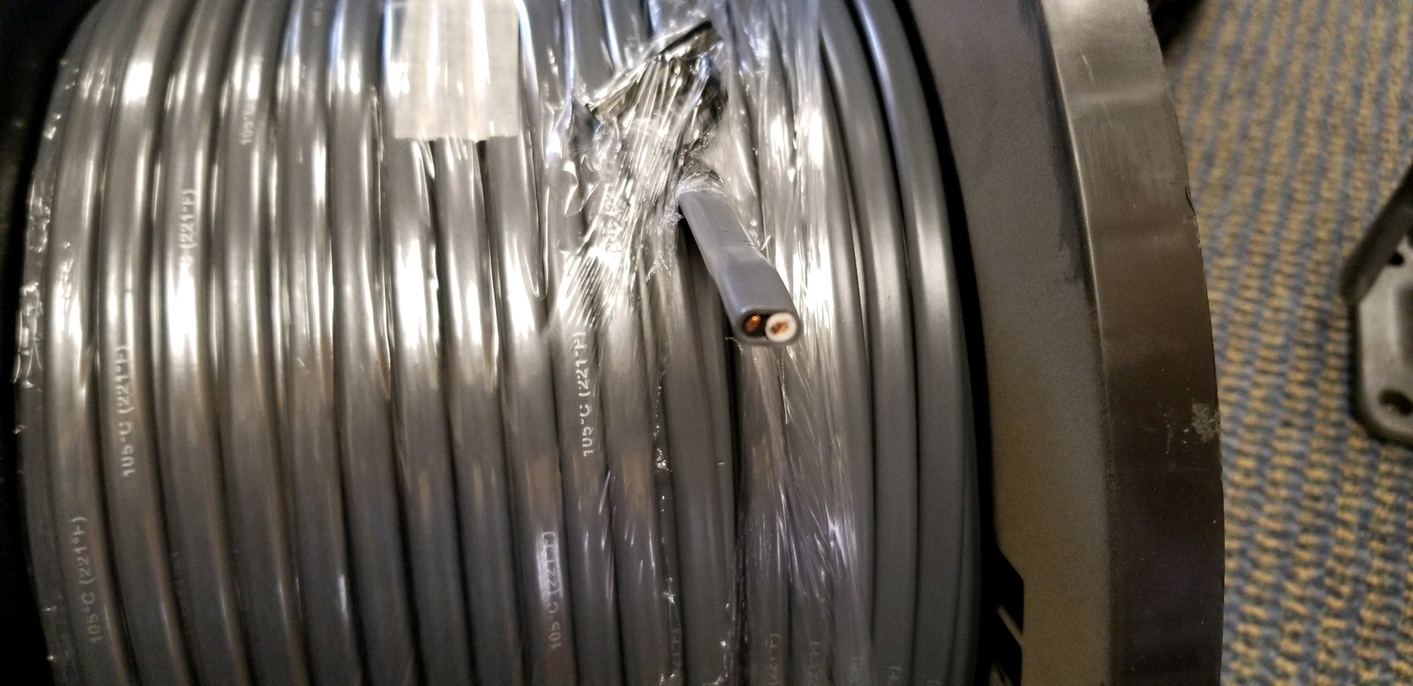 Tex Trail 12/2 black and white electrical wire with gray jacket, sold by the foot, suitable for electrical and lighting projects.