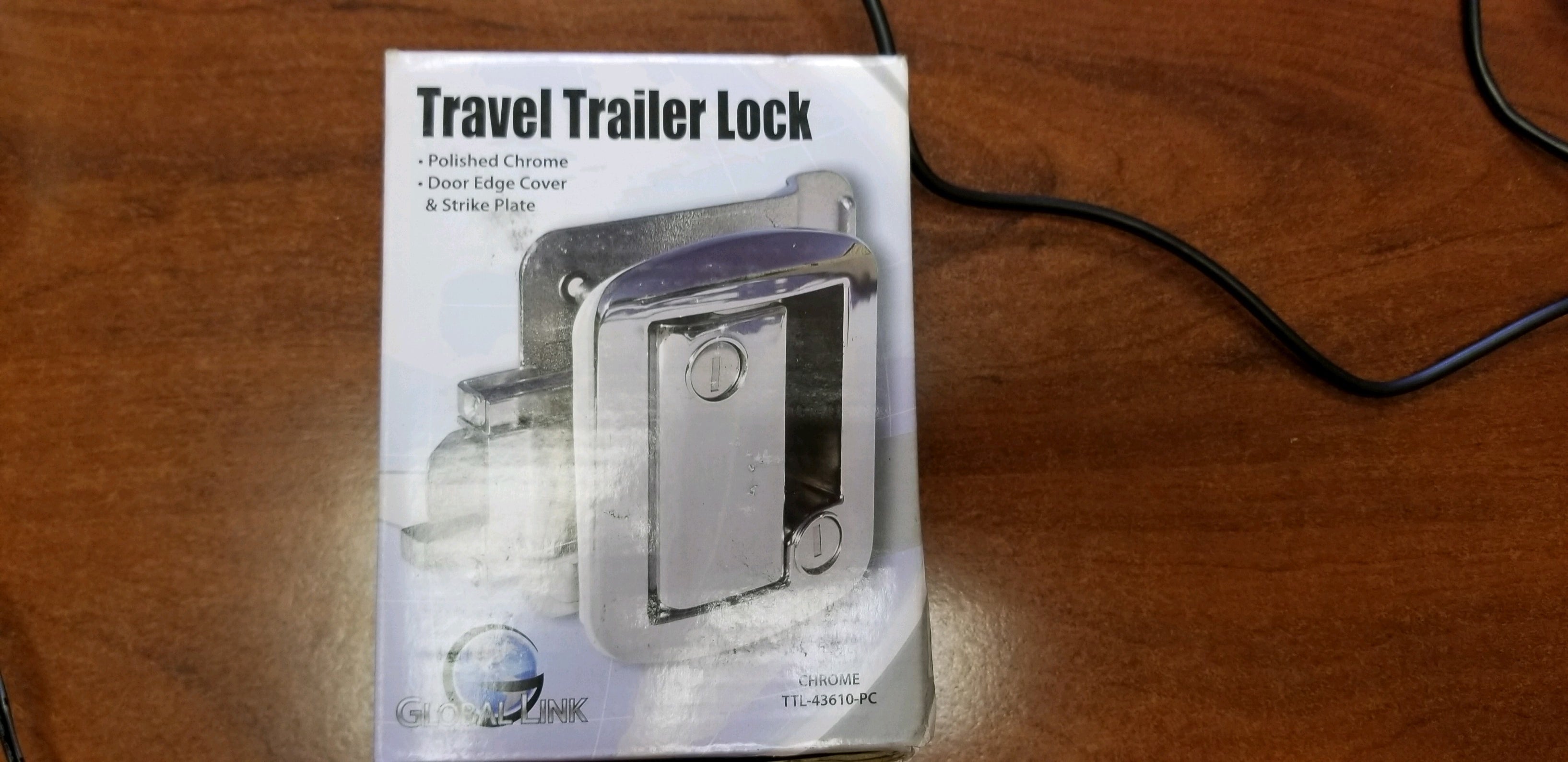 Chrome latch paddle for RV entry door by Tex Trail, part of ramps, gates, and doors collection, shown on RV entrance.